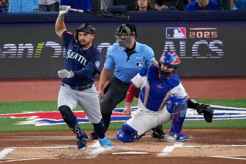 Seattle Mariners' Josh Naylor follows through on an RBI base hit off Toronto Blue Jays pitcher Shane Bieber (57) during the first inning in Game 7 of baseball's American League Championship Series, Monday, Oct. 20, 2025, in Toronto. (AP Photo/David J. Phillip)