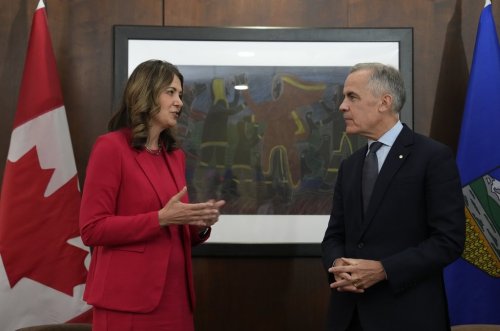 Prime Minister Mark Carney stands with Alberta Premier Danielle Smith at the start of a meeting in Ottawa on Monday, Oct. 6, 2025. THE CANADIAN PRESS/Adrian Wyld