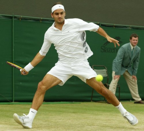 FILE - Switzerland's Roger Federer plays a return to Sjeng Schalken, of the Netherlands, during their men's singles quarter final match at the All England Lawn Tennis Championships at Wimbledon, July 3, 2003. (AP Photo/Alastair Grant, File)