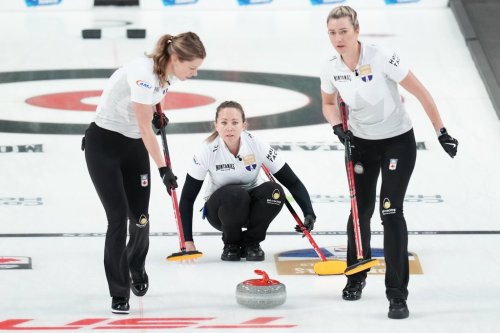 Rachel Homan, centre, throws a rock during Canadian Olympic curling trials action against Team Brown in Halifax, Tuesday, Nov. 25, 2025. THE CANADIAN PRESS/Darren Calabrese