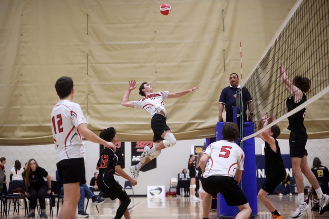 Dylan Granger #10 of the Wawanesa Warriors leaps to put the ball over the net during the Warriors match against the Hamiota Huskies in the A Varsity Boy’s Volleyball Provincials at the Brandon University Healthy Living Centre on Thursday. (Tim Smith/The Brandon Sun)
