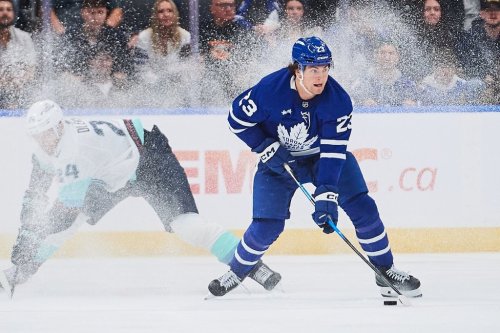Maple Leafs winger Matthew Knies (23) breaks away from Seattle Kraken defenceman Jamie Oleksiak (24) in Toronto on Saturday, Oct. 18, 2025. THE CANADIAN PRESS/Sammy Kogan