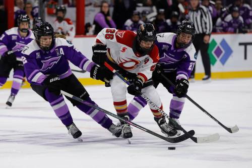 Ottawa Charge forward Emily Clark (26) battles for the puck with Minnesota Frost defender Lee Stecklein (2) and forward Liz Schepers (21) during the second period of Game 3 of the PWHL hockey finals in St. Paul, Minn., on May 24. (The Associated Press files)
