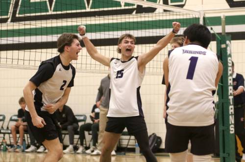 Griffin Zilkey, left, Charlie Gauthier and the Vincent Massey Vikings celebrate their varsity boys’ volleyball city title at Neelin on Wednesday. (Thomas Friesen/The Brandon Sun)