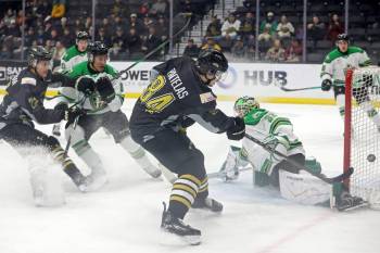 Giorgos Pantelas (84) of the Brandon Wheat Kings tries to get the puck past netminder Dimitri Fortin (33) of the Prince Albert Raiders during WHL action at Assiniboine Credit Union Place on Friday evening. (Tim Smith/The Brandon Sun)