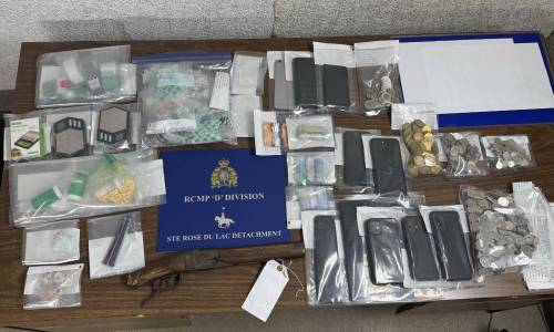 Ste. Rose du Lac RCMP seized illicit drugs, Canadian cash, a shotgun, cellphones and drug paraphernalia while executing a search warrant in Ebb and Flow First Nation on Wednesday. (Supplied)