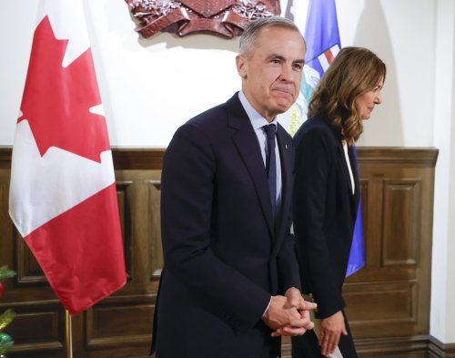 Prime Minister Mark Carney, left, meets with Alberta Premier Danielle Smith in Calgary, Alta., Thursday, Nov. 27, 2025. THE CANADIAN PRESS/Jeff McIntosh