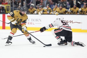 Vegas Golden Knights left wing Brandon Saad (20) skates against Chicago Blackhawks defenseman Artyom Levshunov (55) during the second period of an NHL hockey game Tuesday, Dec. 2, 2025, in Las Vegas. (AP Photo/Ian Maule)