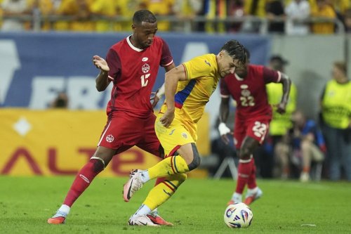 Canada's Derek Cornelius, left, challenges for the ball with Romania's Andrei Ratiu during an international friendly soccer match between Romania and Canada at the National Arena stadium in Bucharest, Romania, Friday, Sept. 5, 2025. (AP Photo/Andreea Alexandru)