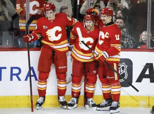 Calgary Flames' Blake Coleman, centre, celebrates his goal with teammates Sam Honzek, left, and Mikael Backlund during second period NHL hockey action against the San Jose Sharks in Calgary on Thursday, Nov. 13, 2025.THE CANADIAN PRESS/Jeff McIntosh