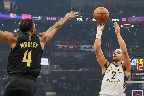 Indiana Pacers guard Andrew Nembhard (2) shoots as Cleveland Cavaliers centre Evan Mobley (4) defends in the first half of an NBA Cup basketball game Friday, Nov. 21, 2025, in Cleveland. (AP Photo/Sue Ogrocki)
