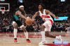 Toronto Raptors guard Immanuel Quickley (5) and Portland Trail Blazers forward Jerami Grant (9) battle for the ball during second half NBA basketball action in Toronto on Tuesday, Dec. 2, 2025. THE CANADIAN PRESS/Nathan Denette