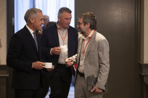Prime Minister Mark Carney speaks with Minister of Canadian Identity and Culture Steven Guilbeault as he arrives to deliver remarks at the Liberal caucus meeting in Edmonton on Wednesday, Sept. 10, 2025. THE CANADIAN PRESS/Amber Bracken