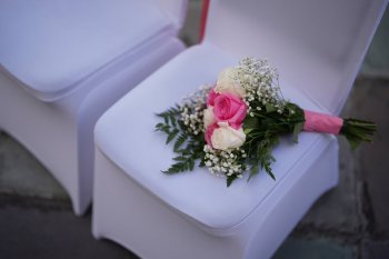 FILE - A bouquet of flowers rests on a chair at a wedding ceremony at the Dade County Courthouse in Miami, Feb. 14, 2025. (AP Photo/Rebecca Blackwell, File)
