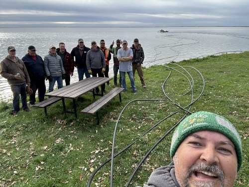 Mark Lowdon (right) is seen with volunteers at Oak Lake during an installation day for aeration technology in November. The system is expected to help fish survive winters, prevent algae blooms, and improve the health of the lake. (Photos provided by Mark Lowdon)
