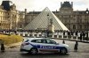 FILE - A police car parks in the courtyard of the Louvre museum, one week after the robbery, on Oct. 26, 2025, in Paris. (AP Photo/Thomas Padilla, File)