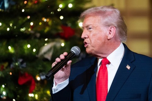 President Donald Trump speaks before a concert by Andrea Bocelli in the East Room of the White House walking towards the East Room, Friday, Dec. 5, 2025, in Washington. (AP Photo/Allison Robbert)