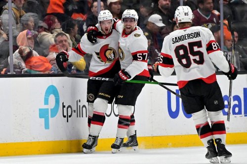 CORRECTS TO THIRD PERIOD - Ottawa Senators right wing Drake Batherson, left, is congratulated Senators' left wing David Perron and defenseman Jake Sanderson (85) after scoring the winning goal during the third period of an NHL hockey game against the Anaheim Ducks, Thursday, Nov. 20, 2025, in Anaheim, Calif. (AP Photo/Jayne Kamin-Oncea)