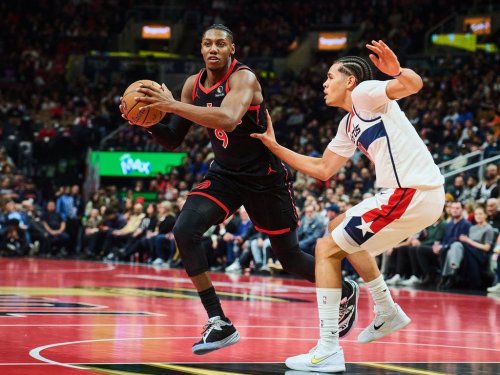 Toronto Raptors' RJ Barrett (9) drives past Washington Wizards' Kyshawn George (18) during first half NBA basketball action in Toronto, on Friday, Nov. 21, 2025. THE CANADIAN PRESS/Sammy Kogan