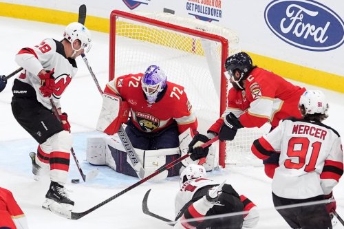 Florida Panthers goaltender Sergei Bobrovsky (72) and defenseman Aaron Ekblad (5) fend off an attack from New Jersey Devils right wing Timo Meier (28) during the third period of an NHL hockey game, Thursday, Nov. 20, 2025, in Sunrise, Fla. (AP Photo/Rebecca Blackwell)
