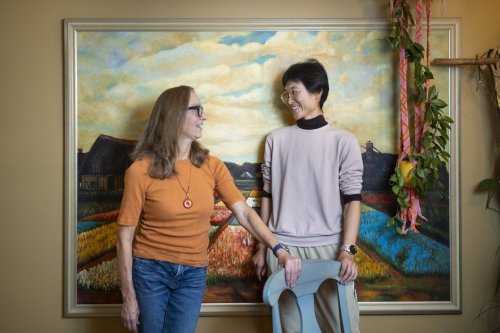 Elaine Jongsma (left) and Li Jiang pose for a photo in their Hamilton, Ont., home on Friday, Nov. 21, 2025. The pair, who both live with Parkinson's disease, met through cycling before becoming friends and roommates. THE CANADIAN PRESS/Nick Iwanyshyn