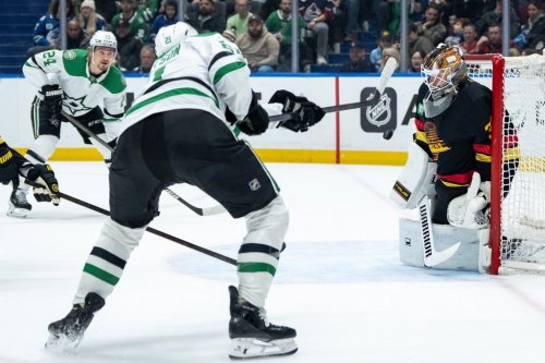 Vancouver Canucks goaltender Kevin Lankinen (32) stops Dallas Stars' Jason Robertson (21) as Roope Hintz (24) watches during the first period of an NHL hockey game in Vancouver, on Thursday, November 20, 2025. THE CANADIAN PRESS/Ethan Cairns