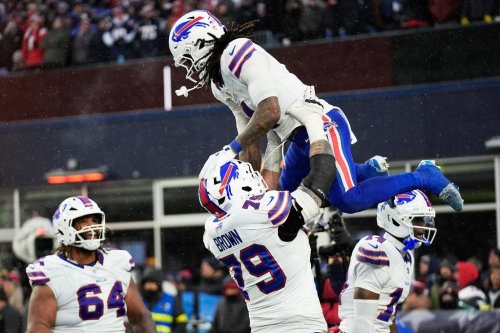 Buffalo Bills running back James Cook III, top, celebrates with offensive tackle Spencer Brown (79) after scoring against the New England Patriots during the second half of an NFL football game in Foxborough, Mass., Sunday, Dec. 14, 2025. (AP Photo/Robert F. Bukaty)