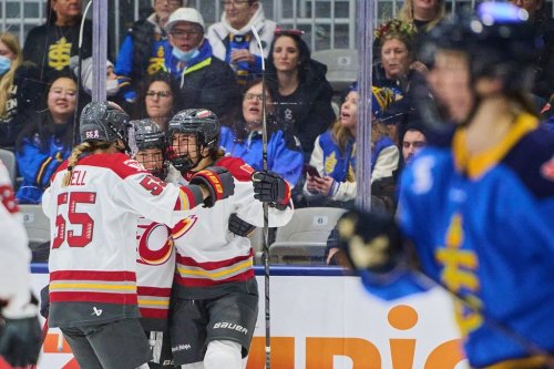 Ottawa Charge's Brooke Hobson (11), right, celebrates with teammates Samantha Isbell (55), left, and Katerina Mrazova (16), after scoring against the Toronto Sceptres during third period PWHL hockey action in Toronto, on Tuesday, Dec. 23, 2025. THE CANADIAN PRESS/Sammy Kogan