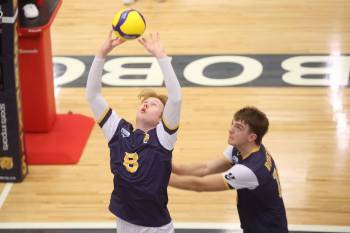 Brandon University's Kale Fisher sets while Matthew Siebenga approaches behind him during the first semester of the Canada West men's volleyball season. (Tim Smith/The Brandon Sun)