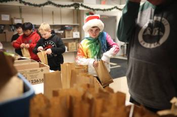 Grade 5-6 students from Green Acres School pack bags of candy to go into Christmas hampers at the Brandon-Westman Christmas Cheer Registry at Rosser Avenue and Seventh Street on Tuesday afternoon. This year, 1,710 Brandon families registered for Christmas Cheer hampers, an increase from the 1,551 who registered last year. The registry is asking for close to 200 individuals or groups to adopt a family and provide them with a Christmas hamper that matches what the Registry provides. Anyone interested can sign up via the Brandon-Westman Christmas Cheer website and will be provided with a list of items to purchase to fill the hamper. The registry is also looking for volunteers to deliver hampers within the city on Dec. 17 and 18. Volunteers began packing hampers on Nov. 27. (Tim Smith/The Brandon Sun)