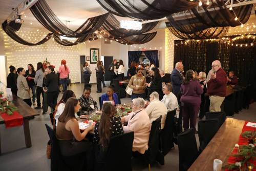 Visitors mingle at the Her Seat at the Table open house at The Backyard On Aberdeen in Brandon on Wednesday evening. (Tim Smith/The Brandon Sun)