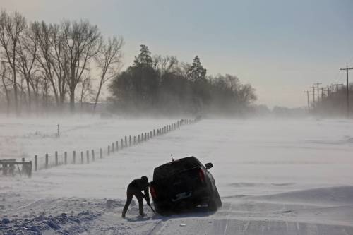 LEFT: A driver tries to dig a pickup truck out of a snow drift after getting stuck while trying to rescue another stuck vehicle on a grid road just outside Brandon during blizzard conditions in 2022. (File) RIGHT: Wheat City Cycle is busy servicing customers snowmobile&rsquo;s for the 2017, season. As the snowmobiling season approaches, windy weather has been a hiccup for clubs in Westman that have seen trails blown down closer to the ground, and requiring extra snowfall. (File)