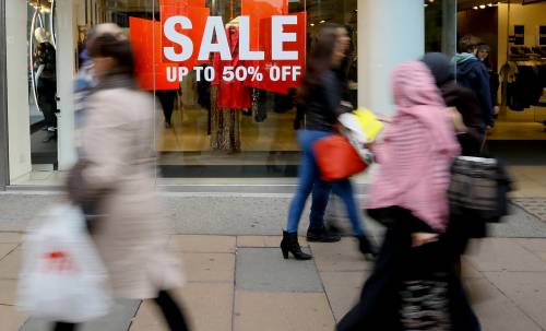 Christmas shoppers pass a sale sign on Oxford Street in London in December 2014. Joanna Pozzulo has some advice for coping with holiday stress. (The Associated Press)