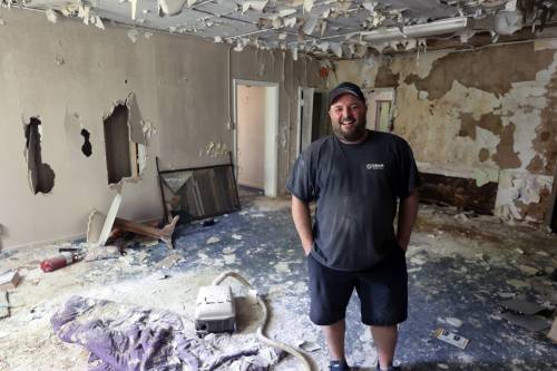 Geoff Gregoire smiles as he sees the interior of a former sanitorium, which has been vacant for decades. Gregoire and his team of tradesmen will completely gut the building, taking out everything except the bones, and then leave it to air dry for months before refurbishing the structure as apartments. (Connor McDowell/The Brandon Sun)