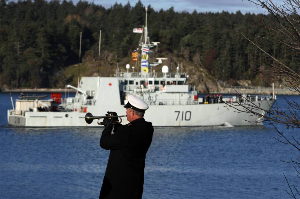 Petty Officer Mike Broadley plays the bugle call as the HMCS Brandon sails by at CFB Esquimalt in Esquimalt, B.C., in 2016 following a six-week deployment. Officials have ruled out moving the recently retired ship to Brandon due to the logistics and cost of transporting it. (The Canadian Press files)