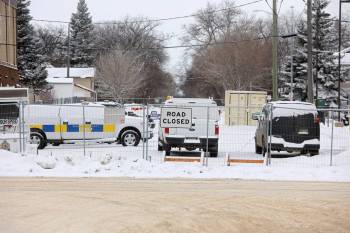 Brandon Police Service vehicles sit parked in a fenced-off portion of McTavish Avenue just west of 10th Street in Brandon on Monday. (Tim Smith/The Brandon Sun)
