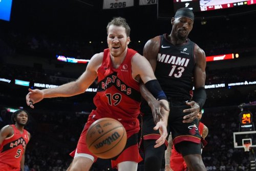 Toronto Raptors center Jakob Poeltl (19) and Miami Heat center Bam Adebayo (13) go for a loose ball during the first half of an NBA basketball game, Monday, Dec. 15, 2025, in Miami. (AP Photo/Lynne Sladky)