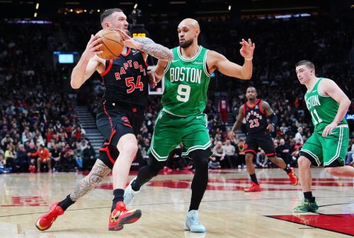 Toronto Raptors' Sandro Mamukelashvili (54) drives as Boston Celtics' Derrick White (9) defends during first half NBA basketball action in Toronto on Saturday, Dec. 20, 2025. THE CANADIAN PRESS/Frank Gunn