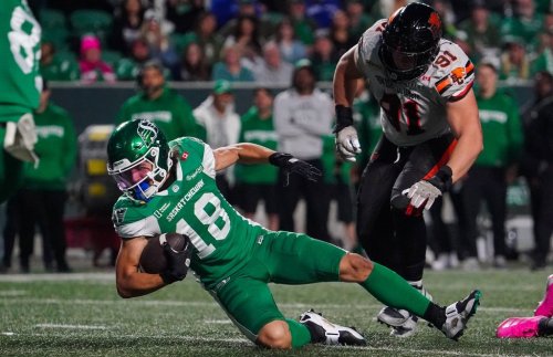 Saskatchewan Roughriders receiver Dhel Duncan-Busby (18) falls as B.C. Lions defensive lineman Nathan Cherry (91) defends during the first half of CFL football action in Regina, on Saturday, October 25, 2025. THE CANADIAN PRESS/Heywood Yu