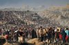 FILE - People carry sacks and boxes of food and humanitarian aid that was unloaded from a World Food Program convoy that had been heading to Gaza City in the northern Gaza Strip, June 16, 2025. (AP Photo/Jehad Alshrafi, File)