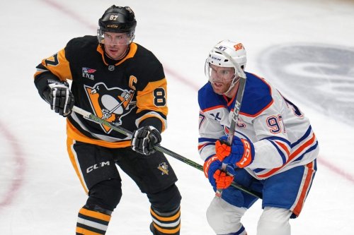 Pittsburgh Penguins' Sidney Crosby (87) defends against Edmonton Oilers' Connor McDavid during the first period of an NHL hockey game in Pittsburgh, Tuesday, Dec. 16, 2025. (AP Photo/Gene J. Puskar)