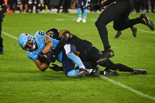 Toronto Argonauts wide receiver David Ungerer (83) is tackled by Hamilton Tiger-Cats defensive back Jamal Peters (2) during second half CFL action in Toronto, on Friday, July 4, 2025. THE CANADIAN PRESS/Sammy Kogan