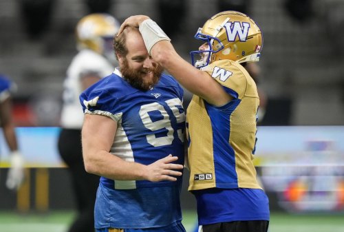 Winnipeg Blue Bombers quarterback Zach Collaros, right, jokes with Jake Thomas during football practice ahead of the 111th CFL Grey Cup, in Vancouver, B.C., Tuesday, Nov. 12, 2024. THE CANADIAN PRESS/Darryl Dyck