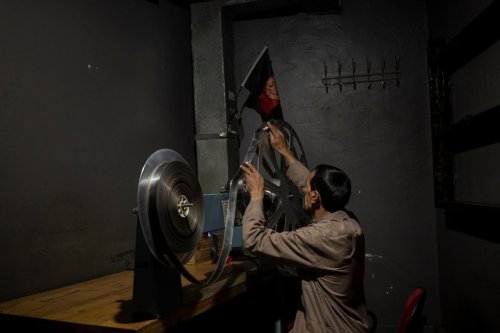 FILE - Rahmatullah Ezati plays back a film reel in the projection room of the historic Ariana Cinema in Kabul, Afghanistan, Nov. 8, 2021, before it was demolished in December 2025 by Taliban authorities to make way for a new shopping center. (AP Photo/Bram Janssen, File)