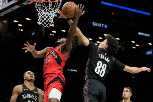 Brooklyn Nets guard Nolan Traore (88) blocks Toronto Raptors guard Immanuel Quickley (5) during the first half of an NBA basketball game, Sunday, Dec. 21, 2025, in New York. (AP Photo/Yuki Iwamura)