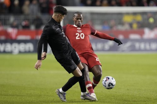 Canada's Jonathan David presses Ecuador's Piero Martin Hincapie during International friendly soccer action in Toronto on Thursday November 13, 2025. THE CANADIAN PRESS/Chris Young