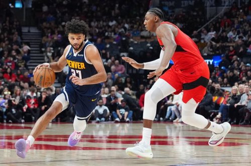 Denver Nuggets guard Jamal Murray (27) moves around Toronto Raptors forward/guard RJ Barrett, right, during first half NBA action in Toronto on Wednesday December 31, 2025.  THE CANADIAN PRESS/Frank Gunn