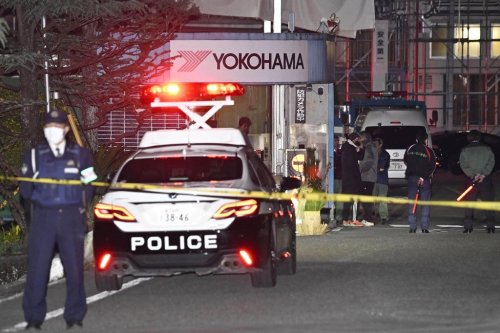 Police officers stand guard at the scene of a stabbing at the Yokohama Rubber Company in Mishima, west of Tokyo, Friday, Dec. 26, 2025. (Yusuke Hashizume/Kyodo News via AP)