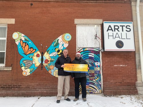 Bruce Luebke (from left) community engagement co-ordinator for Sunrise Credit Union, and
Bradley Peters, treasurer of the Boissevain-Morton Arts Council. The credit union gave money to the arts council that will be used to install new windows and doors at the Arts Hall in Boissevain.