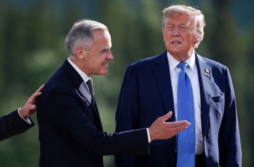 Canadian Prime Minister Mark Carney, left, prompts U.S. President Donald Trump to leave the stage as he responds to questions from reporters after posing for the family photograph during the G7 Summit in Kananaskis, Alta., Monday, June 16, 2025. THE CANADIAN PRESS/Darryl Dyck